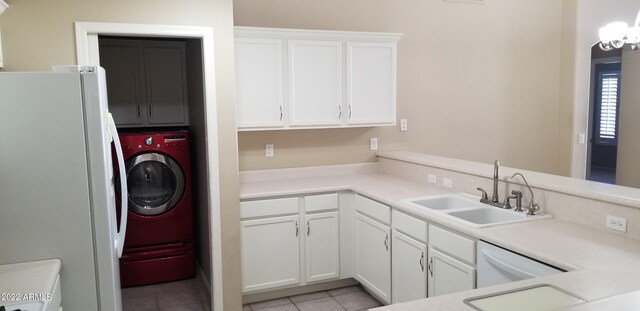 kitchen featuring light tile patterned flooring, white appliances, white cabinets, washer / dryer, and sink