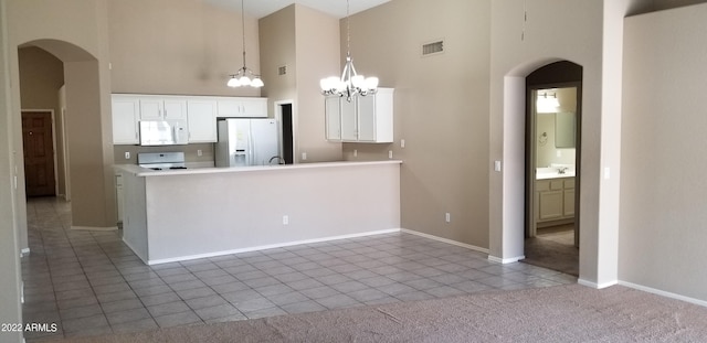 kitchen featuring a chandelier, white cabinetry, white appliances, and light tile patterned floors