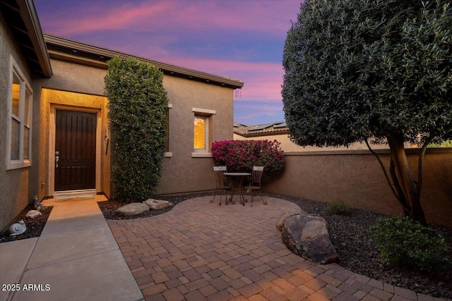 view of patio terrace at dusk