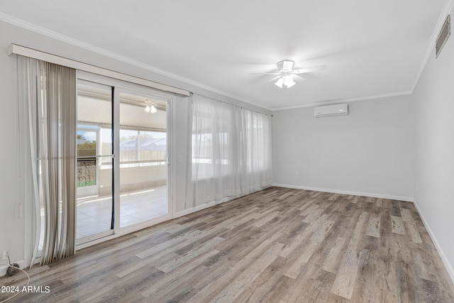 empty room featuring ceiling fan, light wood-type flooring, ornamental molding, and a wall unit AC