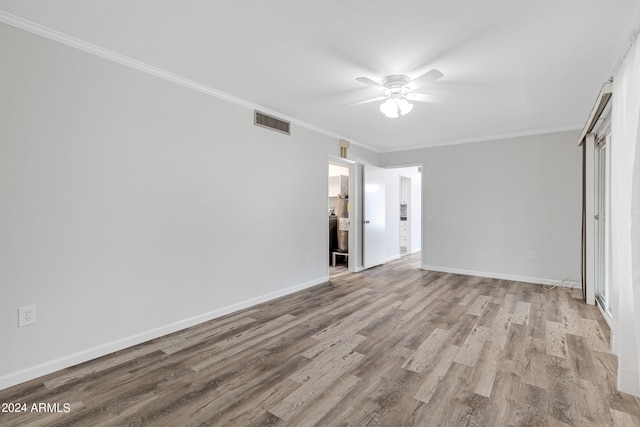 unfurnished bedroom with ornamental molding, ceiling fan, connected bathroom, and light hardwood / wood-style flooring