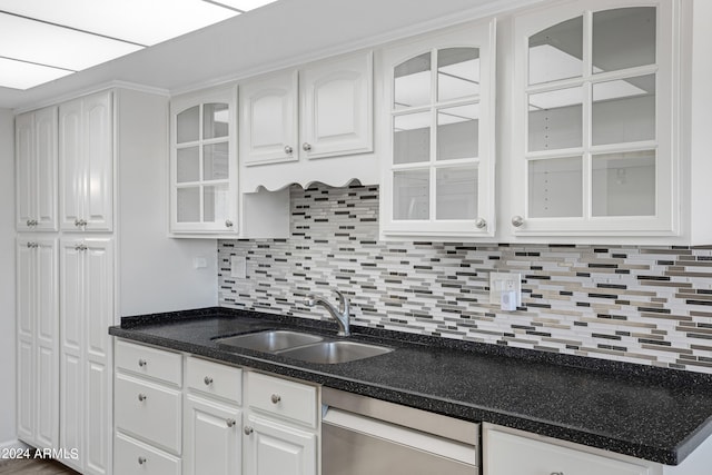 kitchen featuring sink, decorative backsplash, white cabinetry, and stainless steel dishwasher