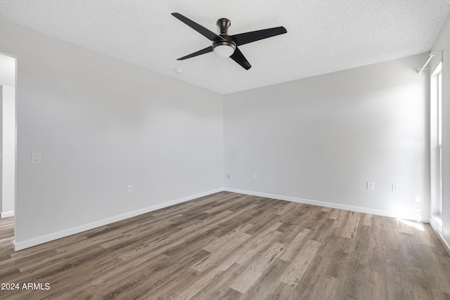 spare room featuring hardwood / wood-style flooring, ceiling fan, and a textured ceiling