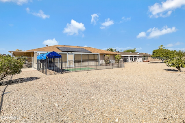 back of property featuring a patio area and a pool