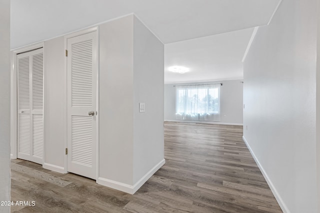 hall with wood-type flooring