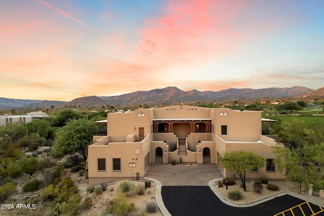 back house at dusk with a mountain view