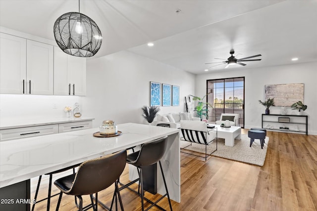 dining room featuring light hardwood / wood-style flooring and ceiling fan