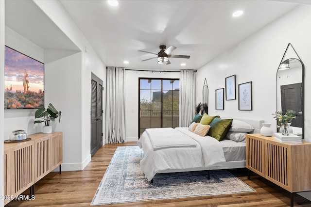 bedroom featuring wood-type flooring, access to outside, and ceiling fan