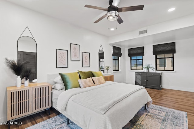 bedroom featuring ceiling fan and dark hardwood / wood-style floors