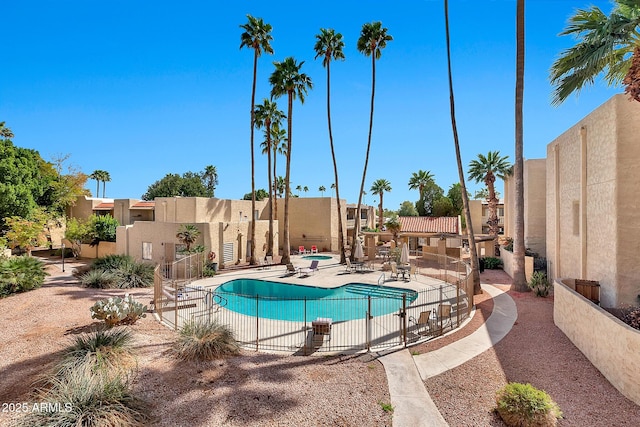 pool with fence and a patio