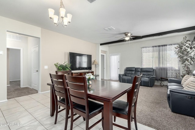 carpeted dining space with ceiling fan with notable chandelier