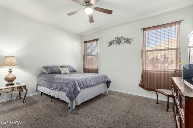 bedroom featuring ceiling fan and dark carpet