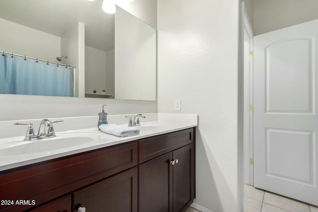 bathroom with tile patterned floors, vanity, and walk in shower