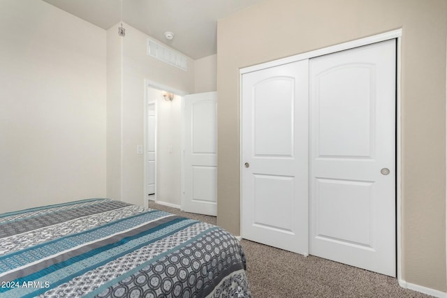 carpeted bedroom with a closet