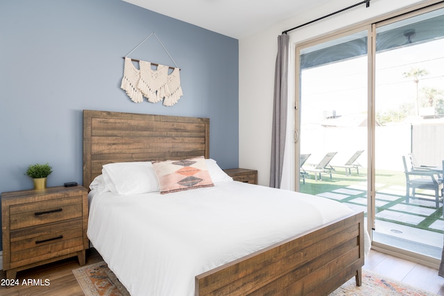 bedroom with wood-type flooring and access to exterior