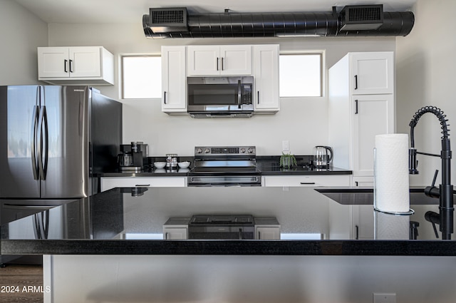 kitchen with white cabinetry, appliances with stainless steel finishes, sink, and dark hardwood / wood-style floors