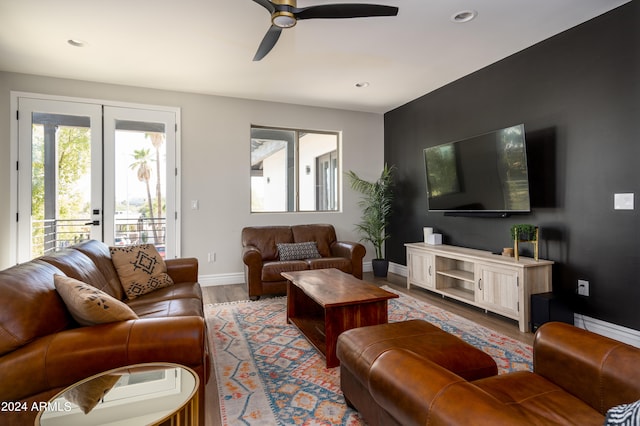 living room with french doors, light hardwood / wood-style flooring, and ceiling fan