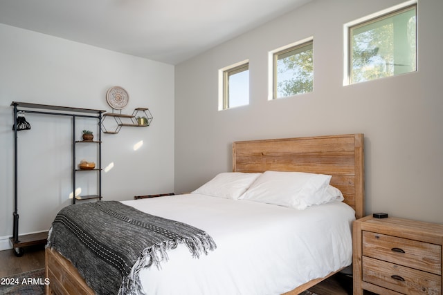 bedroom with dark hardwood / wood-style floors