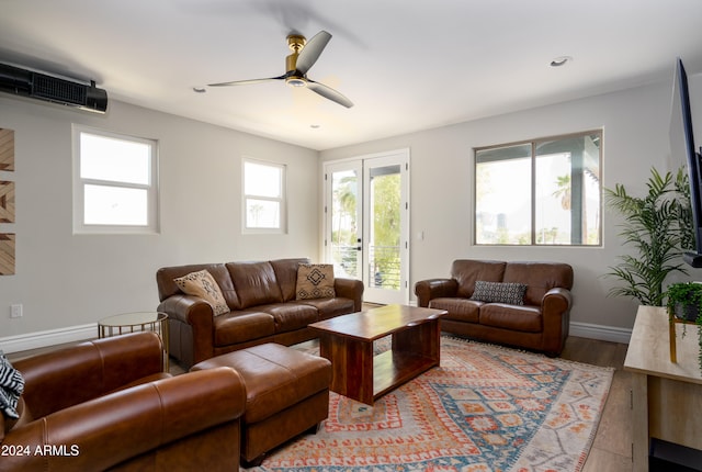 living room featuring light hardwood / wood-style flooring and ceiling fan