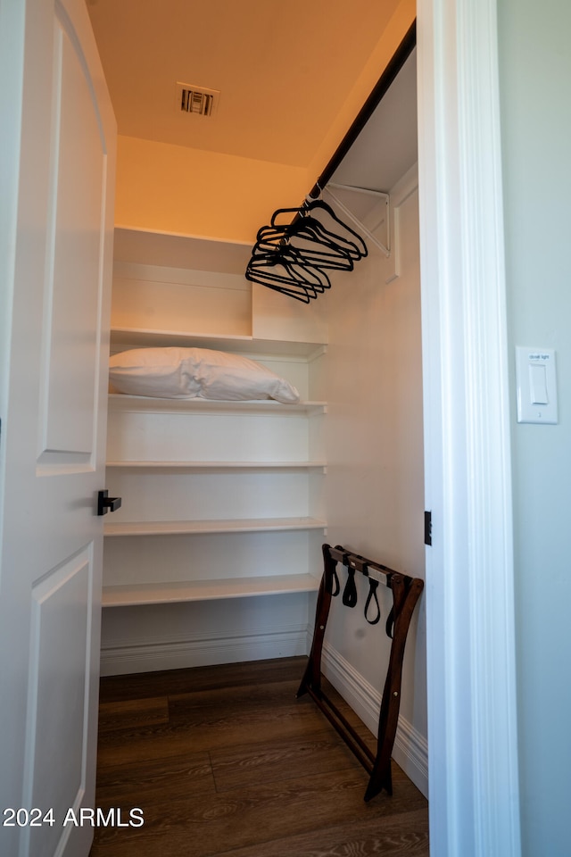 walk in closet featuring dark wood-type flooring