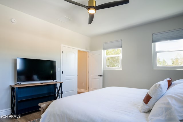 bedroom with dark wood-type flooring and ceiling fan