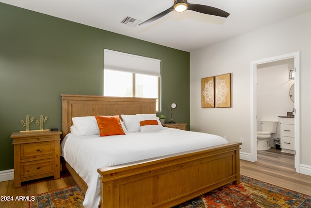 bedroom featuring ensuite bathroom, wood-type flooring, and ceiling fan