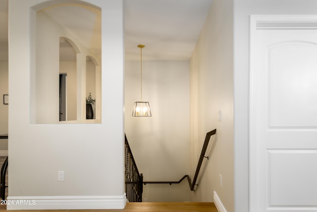 stairs featuring hardwood / wood-style floors