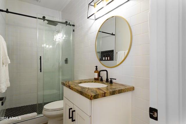 bathroom with vanity, toilet, tile walls, and an enclosed shower