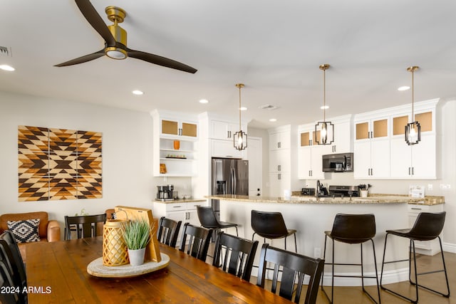 dining area featuring ceiling fan and sink