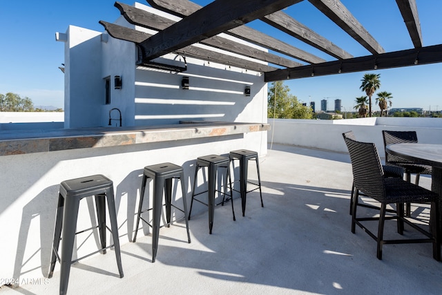 view of patio / terrace featuring a pergola and a bar