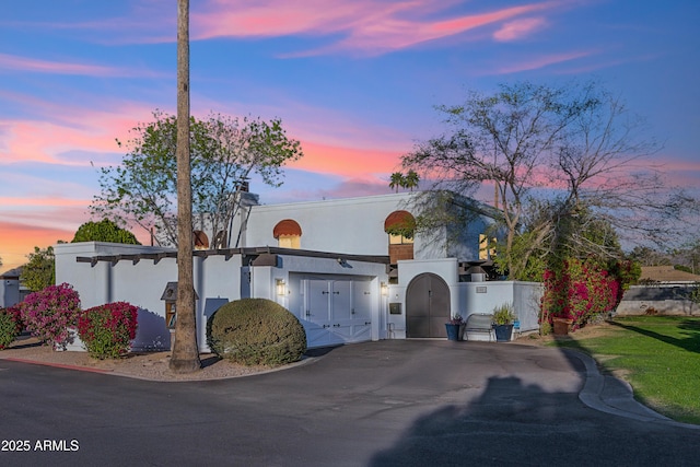 8001 N 3rd Pl, Phoenix, AZ 85020 - mediterranean / spanish home featuring a gate, stucco siding, and asphalt driveway
