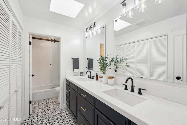 8001 N 3rd Pl, Phoenix, AZ 85020 - bathroom with a closet, double vanity, toilet, and a skylight
