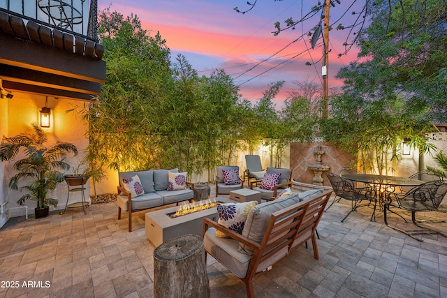 8001 N 3rd Pl, Phoenix, AZ 85020 - patio terrace at dusk with an outdoor living space with a fire pit, a patio, and outdoor dining area