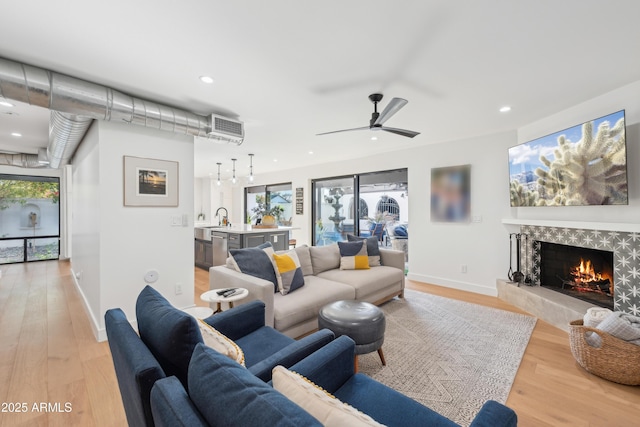 8001 N 3rd Pl, Phoenix, AZ 85020 - living room featuring a fireplace, light wood-type flooring, a ceiling fan, recessed lighting, and baseboards