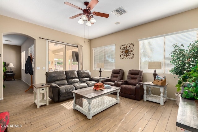 living room featuring ceiling fan and light wood-type flooring