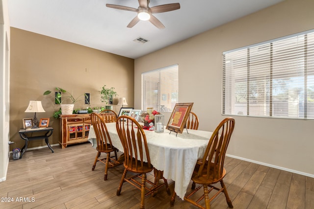 dining room featuring light hardwood / wood-style flooring, ceiling fan, and plenty of natural light