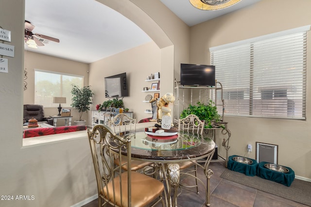 dining area featuring ceiling fan and tile patterned flooring