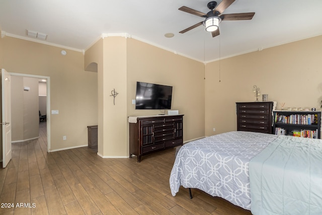 bedroom featuring ornamental molding, hardwood / wood-style flooring, and ceiling fan