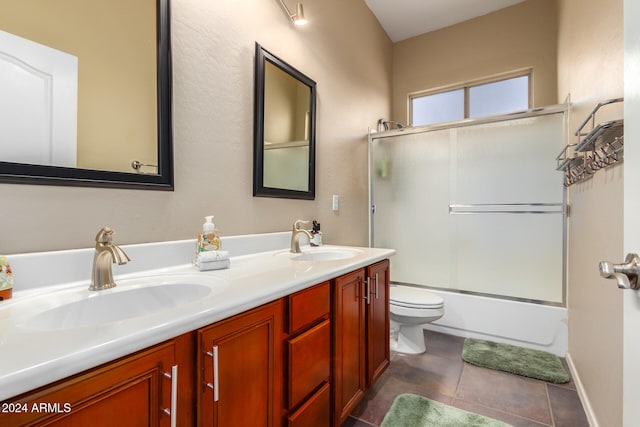 full bathroom with vanity, enclosed tub / shower combo, tile patterned floors, and toilet