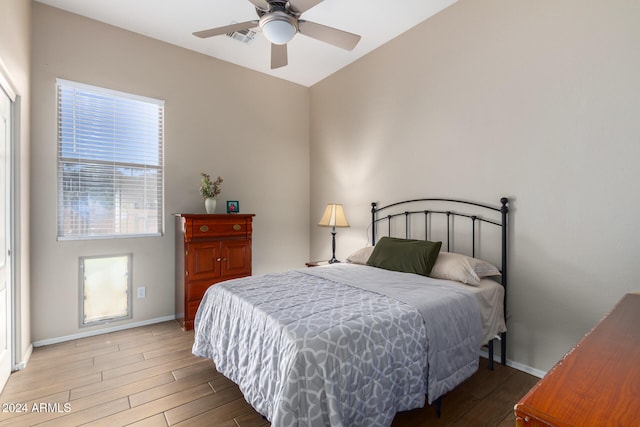 bedroom featuring hardwood / wood-style floors, ceiling fan, and vaulted ceiling