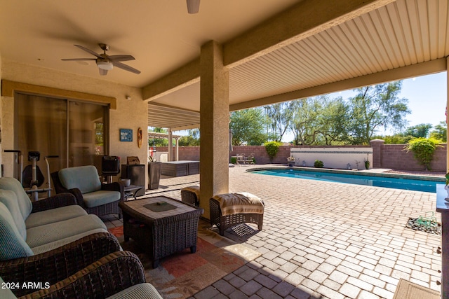 view of patio featuring a fenced in pool, an outdoor living space, and ceiling fan