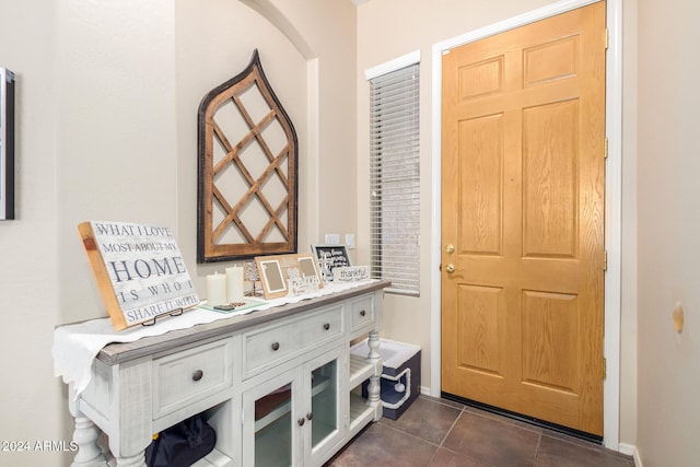 entryway featuring dark tile patterned flooring