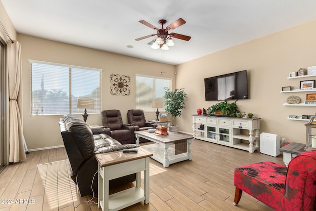 living room featuring ceiling fan and light hardwood / wood-style flooring