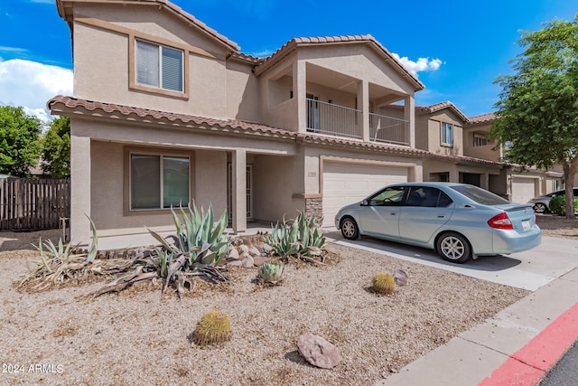 view of front of property featuring a balcony and a garage