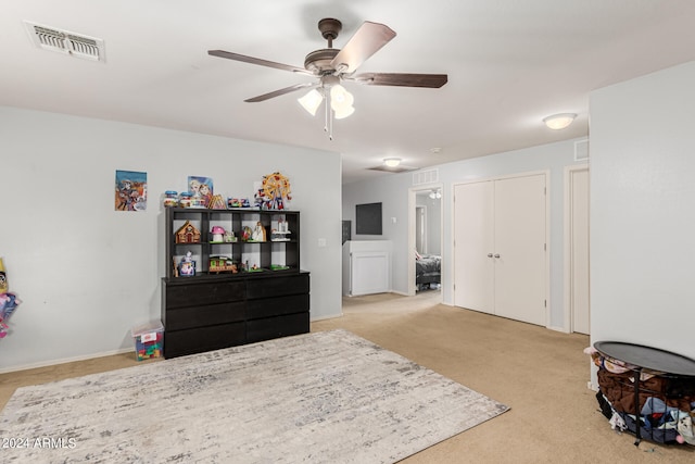 carpeted bedroom with ceiling fan and a closet