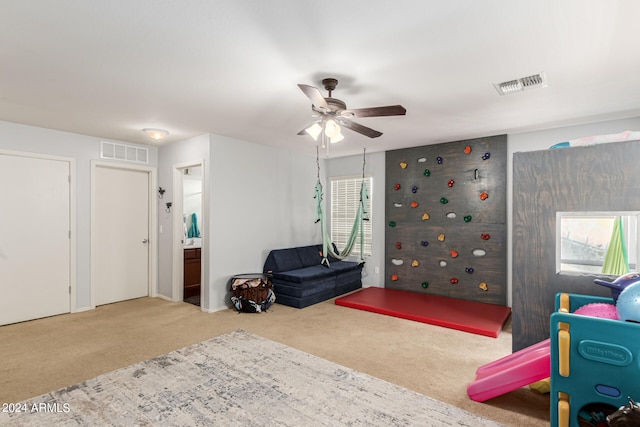 interior space featuring ceiling fan, ensuite bathroom, and carpet floors