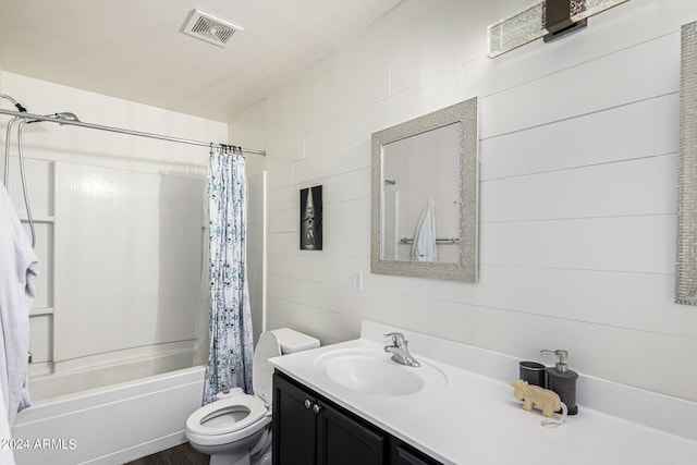 full bathroom featuring tile walls, toilet, vanity, and shower / tub combo