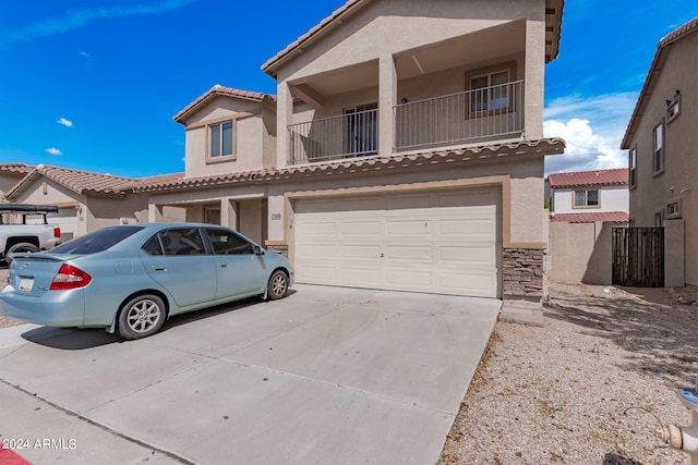 view of front of property with a balcony and a garage