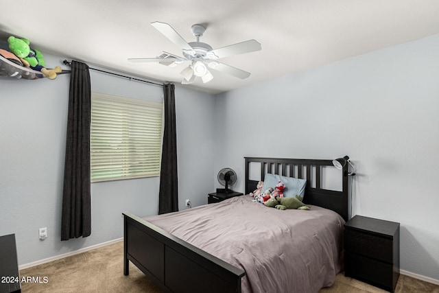 bedroom with ceiling fan and light carpet