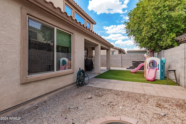 view of yard featuring a patio area and a playground